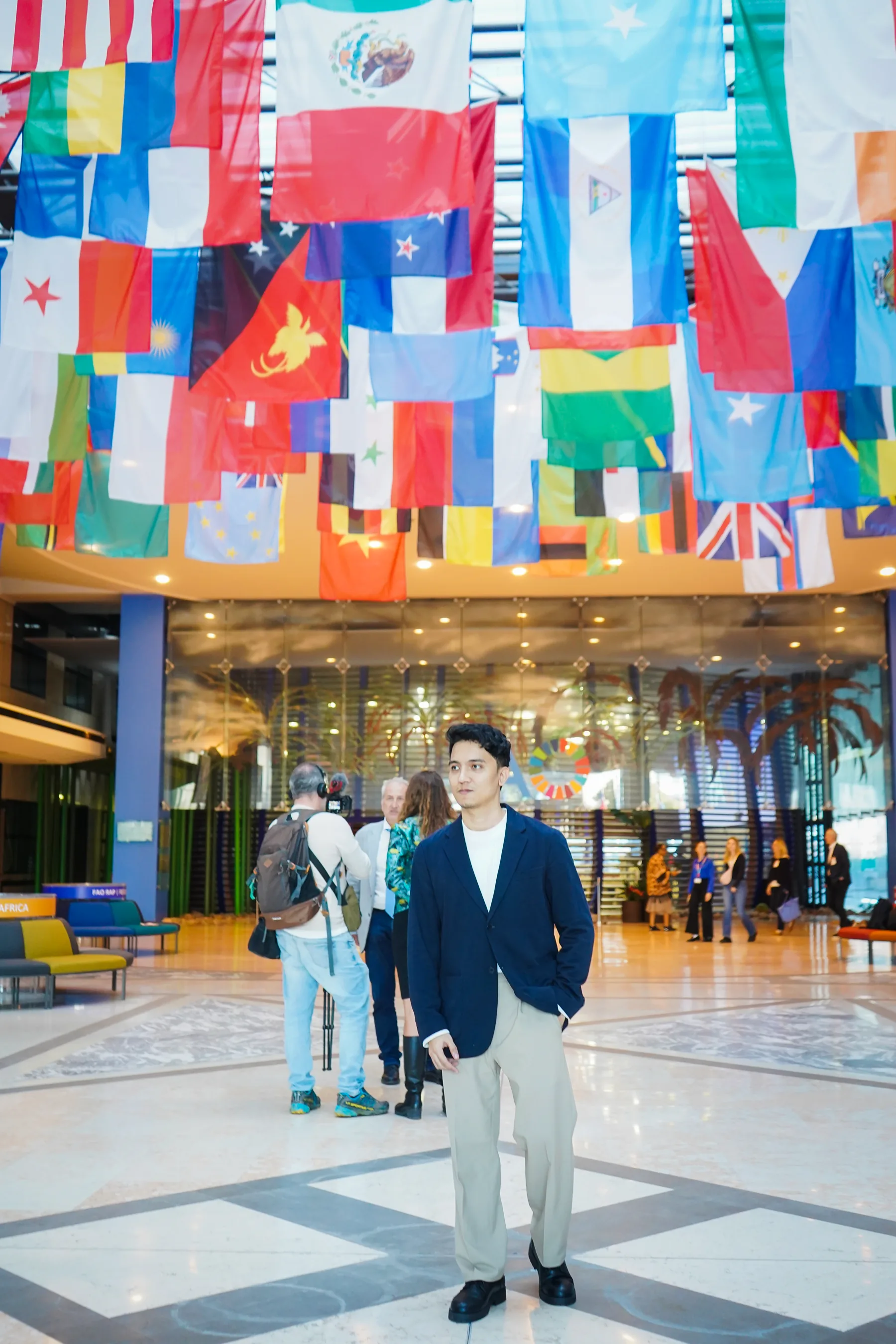 Alvin Baloloy beneath the international flags at FAO Headquarters