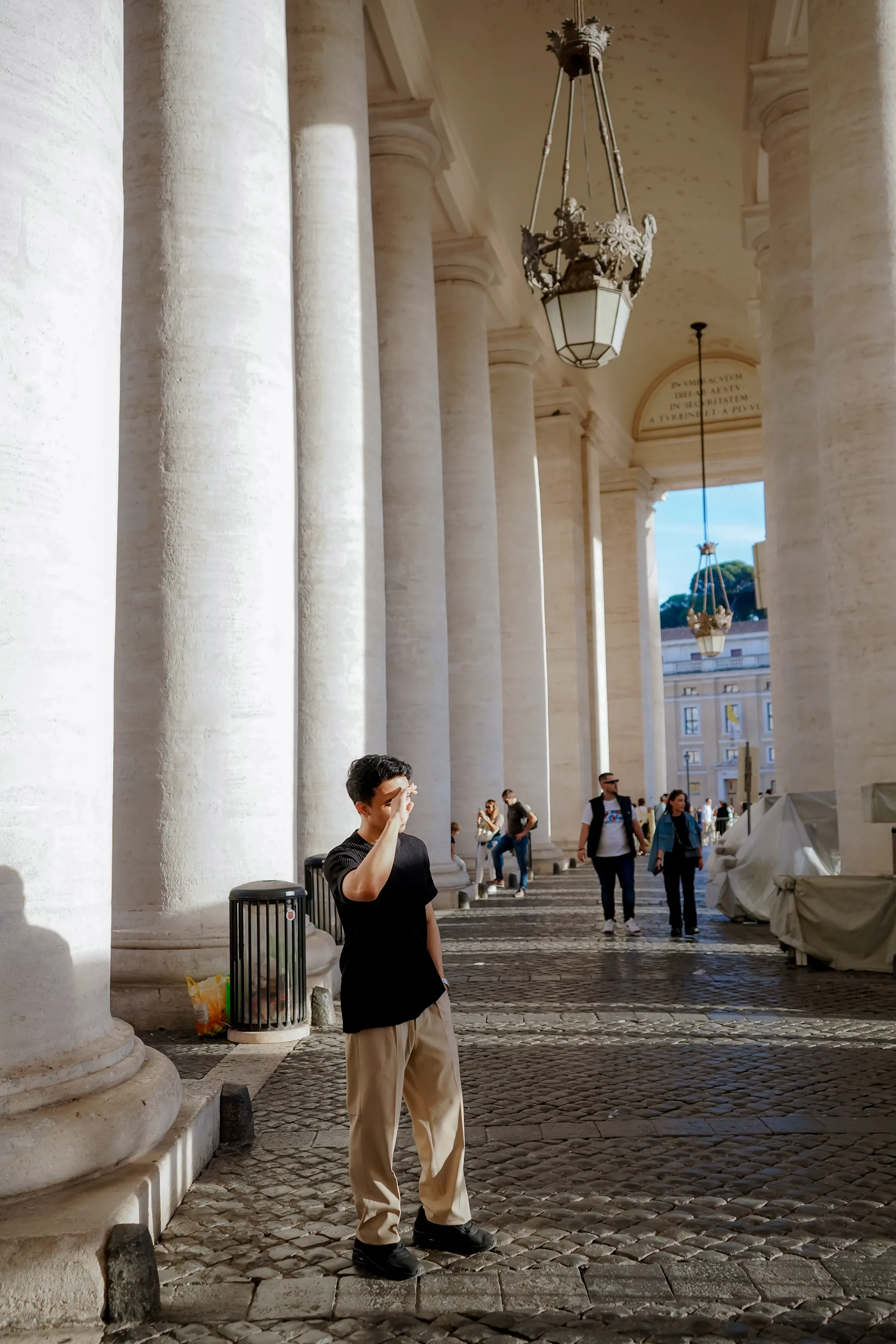 Alvin Baloloy walking through the colonnade near Saint Peter's Square