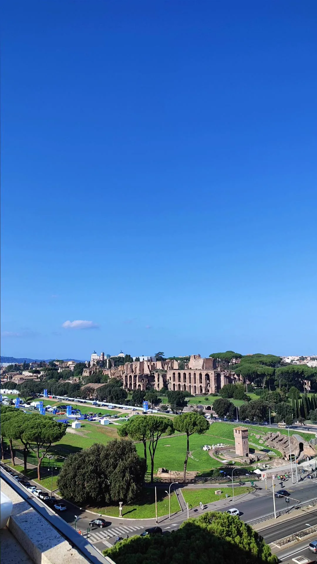 A panoramic view of historic Rome under a clear blue sky