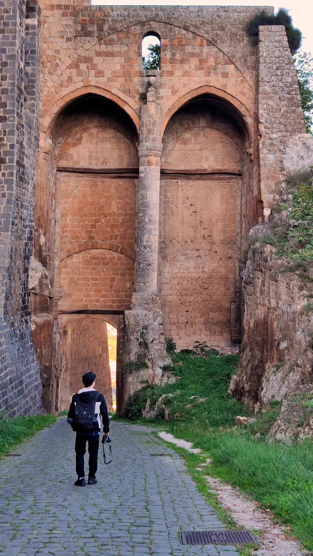Alvin Baloloy walking through historic stone architecture in Orvieto